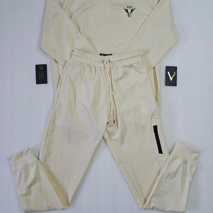Beige long-sleeve top and pants set with brand logo on a white background