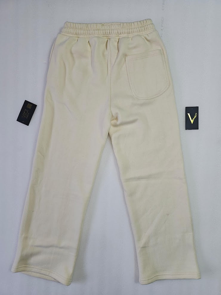 Beige pants with brand labels on a white background